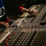 a sound engineer on the control panel of a recording studio